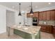 Bright kitchen with a large island, stone countertops, and stainless steel appliances at 13204 W Palo Verde Dr, Litchfield Park, AZ 85340
