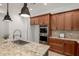 Close-up of kitchen area with stainless steel appliances and breakfast bar at 13204 W Palo Verde Dr, Litchfield Park, AZ 85340