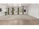 Expansive living room with large windows, neutral carpeting, and a modern chandelier at 13204 W Palo Verde Dr, Litchfield Park, AZ 85340