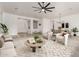 Bright living room featuring neutral tones, modern ceiling fan, and open layout to the dining area at 13204 W Palo Verde Dr, Litchfield Park, AZ 85340