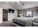 Bright bedroom features carpet, ceiling fan, and ample natural light from a large window at 136 W Brahman Blvd, San Tan Valley, AZ 85143