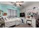 Relaxing bedroom with ample natural light, a ceiling fan, and soothing color scheme at 136 W Brahman Blvd, San Tan Valley, AZ 85143