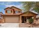 Inviting two-story home with a neutral palette, desert landscaping, covered porch, and a two-car garage at 136 W Brahman Blvd, San Tan Valley, AZ 85143