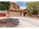 Charming two-story home featuring desert landscaping, a long driveway, and a cozy covered porch entry at 136 W Brahman Blvd, San Tan Valley, AZ 85143
