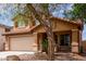 Inviting two-story home with a neutral palette, desert landscaping, covered porch, and a two-car garage at 136 W Brahman Blvd, San Tan Valley, AZ 85143