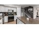 Modern kitchen with stainless steel appliances and granite countertops with a staircase view at 136 W Brahman Blvd, San Tan Valley, AZ 85143
