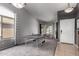 Open-concept living room with high vaulted ceilings, pendant lights, a ping pong table, and tiled entry at 136 W Brahman Blvd, San Tan Valley, AZ 85143