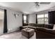 Cozy living room boasts a modern sectional sofa, neutral colors, and natural light at 136 W Brahman Blvd, San Tan Valley, AZ 85143
