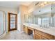 Bathroom featuring dual sinks, vanity, tile floors, and a glass shower at 13650 N 70Th Dr, Peoria, AZ 85381