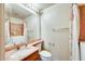 Bathroom features a vanity, toilet, and shower with a floral curtain at 13650 N 70Th Dr, Peoria, AZ 85381