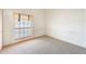 Bright bedroom with neutral carpet, window with blinds, and plenty of natural light at 13650 N 70Th Dr, Peoria, AZ 85381