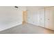 Clean bedroom features neutral carpet, white walls, and a closet with sliding doors at 13650 N 70Th Dr, Peoria, AZ 85381
