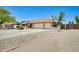 Home exterior showcasing a well-maintained house with a two-car garage and desert landscaping at 13650 N 70Th Dr, Peoria, AZ 85381