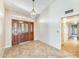 Welcoming home foyer featuring tile flooring, a decorative light fixture, and a custom wood door at 13650 N 70Th Dr, Peoria, AZ 85381
