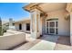 Covered front entrance featuring architectural details, landscaping, and a secure front door at 13650 N 70Th Dr, Peoria, AZ 85381
