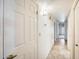 Hallway features neutral walls, tile flooring, doors, and light fixtures at 13650 N 70Th Dr, Peoria, AZ 85381