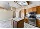 Bright kitchen with oak cabinets, stainless steel oven, granite countertops and tile flooring at 13650 N 70Th Dr, Peoria, AZ 85381