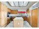 Well-lit kitchen featuring an island, oak cabinets and stainless steel appliances at 13650 N 70Th Dr, Peoria, AZ 85381