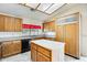 Kitchen with island, wood cabinets, granite countertops and modern appliances at 13650 N 70Th Dr, Peoria, AZ 85381