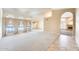 Bright living room featuring arched windows, carpeted flooring, and an open layout at 13650 N 70Th Dr, Peoria, AZ 85381