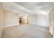 Large living room featuring carpet, neutral walls, and a view of the front door at 13650 N 70Th Dr, Peoria, AZ 85381