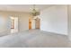 Open main bedroom boasts a ceiling fan, walk-in closet, and neutral carpeting at 13650 N 70Th Dr, Peoria, AZ 85381