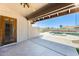 Covered patio with a ceiling fan overlooking the beautiful pool area at 13650 N 70Th Dr, Peoria, AZ 85381