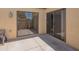 Private back patio featuring sliding glass doors, neutral colored walls, and low maintenance desert landscaping at 1506 N Oak St, Tempe, AZ 85288
