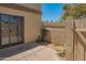 Private back patio featuring sliding glass doors, neutral colored walls, and low maintenance desert landscaping at 1506 N Oak St, Tempe, AZ 85288