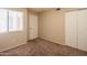 A cozy bedroom with plush carpet, neutral walls, closet and a window providing natural light at 1506 N Oak St, Tempe, AZ 85288