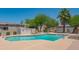 Community pool with lounge chairs, desert landscaping and perimeter fencing offers a relaxing spot for neighborhood residents at 1506 N Oak St, Tempe, AZ 85288