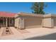 Beige garage door in a neutral colored home with a red tile roof, desert landscaping, and a private driveway at 1506 N Oak St, Tempe, AZ 85288