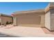 Beige garage door in a neutral-colored home with a red tile roof, desert landscaping, and a private driveway at 1506 N Oak St, Tempe, AZ 85288