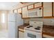 Well-equipped kitchen featuring white appliances and plenty of cabinet space for storage at 1506 N Oak St, Tempe, AZ 85288