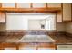 Kitchen view into living area with fireplace, providing an open concept feel and seamless entertaining space at 1506 N Oak St, Tempe, AZ 85288