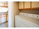 Convenient laundry room with a washer, dryer, and storage cabinets, adjacent to the kitchen at 1506 N Oak St, Tempe, AZ 85288