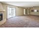 Spacious living room showcasing a fireplace, sliding glass doors, and access to other rooms at 1506 N Oak St, Tempe, AZ 85288