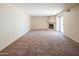 Bright living room with sliding glass doors, a fireplace, and neutral walls and carpet at 1506 N Oak St, Tempe, AZ 85288