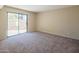 Bedroom with sliding glass doors leading to patio, neutral walls, and carpeting at 1506 N Oak St, Tempe, AZ 85288
