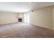 Living room featuring a fireplace, sliding glass doors, and neutral walls and carpet at 1506 N Oak St, Tempe, AZ 85288