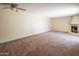 Spacious living room featuring a fireplace, neutral walls and carpet, and ceiling fan at 1506 N Oak St, Tempe, AZ 85288