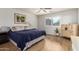 Calm bedroom with wood flooring, a large window, and a comfortable bed with stylish linens at 16031 W Williams St, Goodyear, AZ 85338