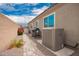 Backyard view featuring a pathway, HVAC unit, shed, and grill at 16031 W Williams St, Goodyear, AZ 85338