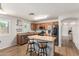 Bright kitchen featuring stainless steel appliances, wooden cabinets, and an island with bar stools at 16031 W Williams St, Goodyear, AZ 85338
