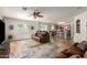 Bright living area with a ceiling fan, comfortable seating, and a view of the kitchen at 16031 W Williams St, Goodyear, AZ 85338