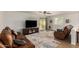Spacious living area with a television, comfortable leather seating, and access to the backyard at 16031 W Williams St, Goodyear, AZ 85338