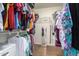 Walk-in closet with hanging clothes and built-in shelving for maximum storage at 16031 W Williams St, Goodyear, AZ 85338