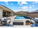 Seating area featuring a modern fireplace in the backyard with a luxurious pool at 16226 S 35Th Dr, Phoenix, AZ 85045