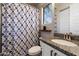 Bathroom featuring a patterned shower curtain, granite countertops, and white vanity at 16226 S 35Th Dr, Phoenix, AZ 85045