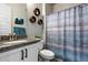Bathroom featuring a vanity with granite countertop, decor, a shower/tub with shower curtain at 16226 S 35Th Dr, Phoenix, AZ 85045